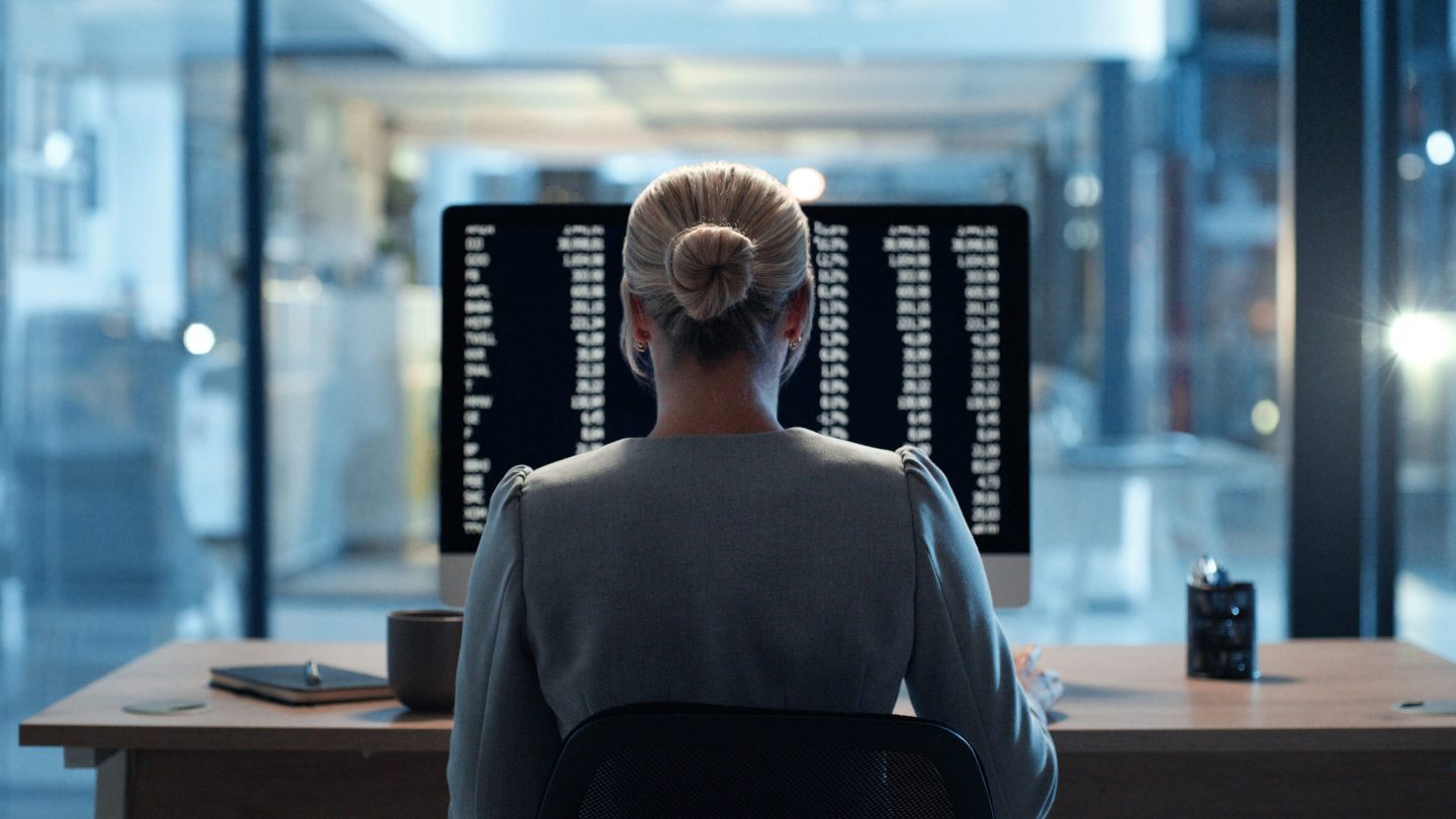 Banker working at laptop at desk