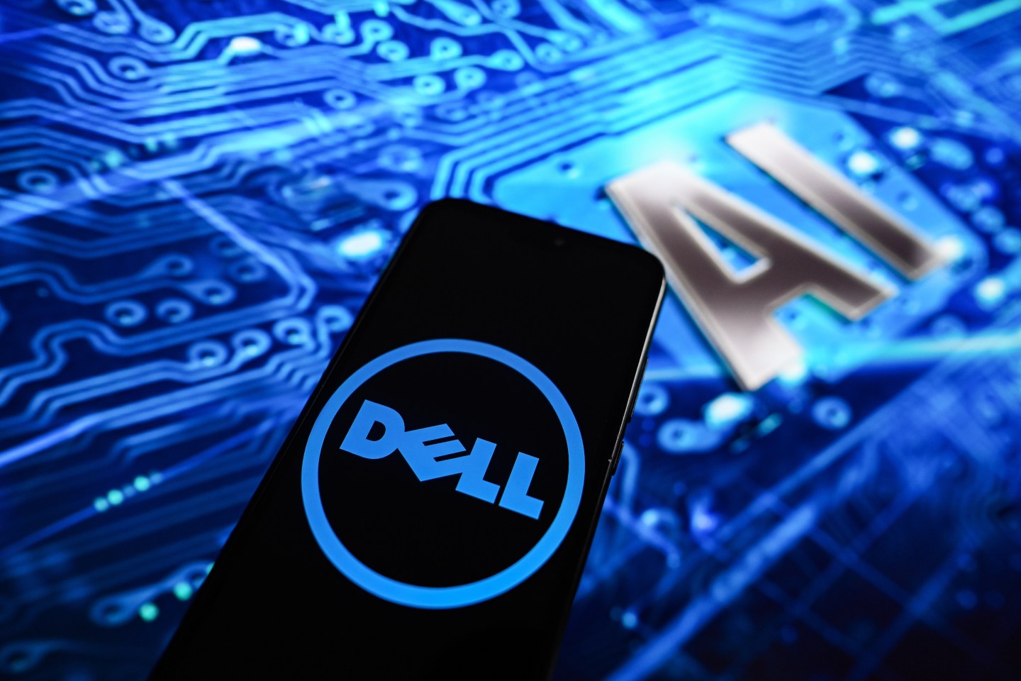 In this photo illustration, a Dell logo displayed on a smartphone with Artificial Intelligence (AI) design in the background.