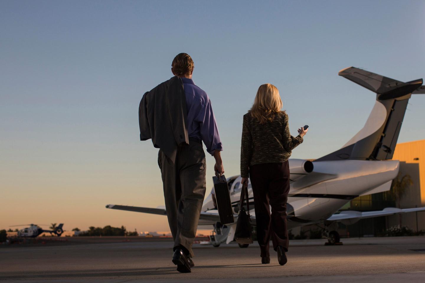 Business people on airplane runway