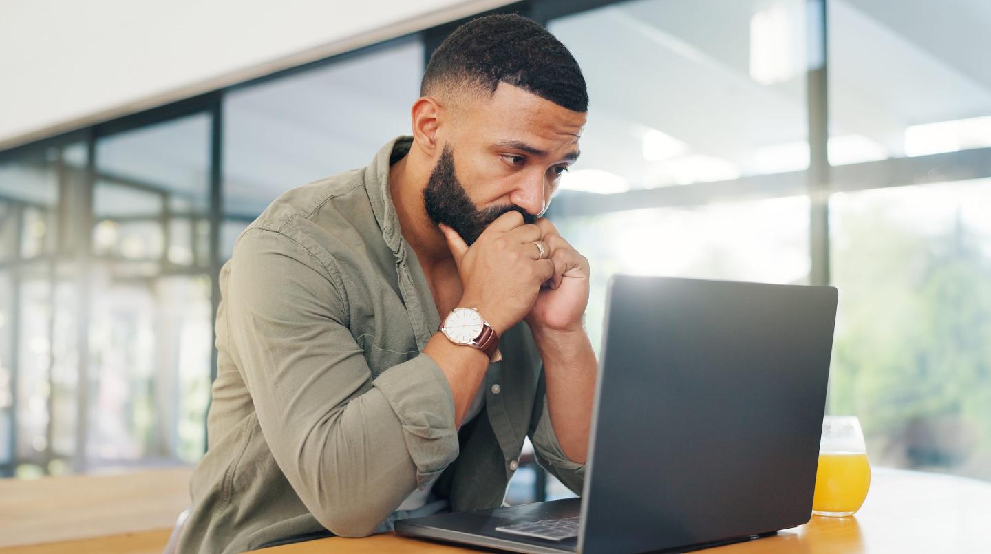 Stressed out job seeker on laptop