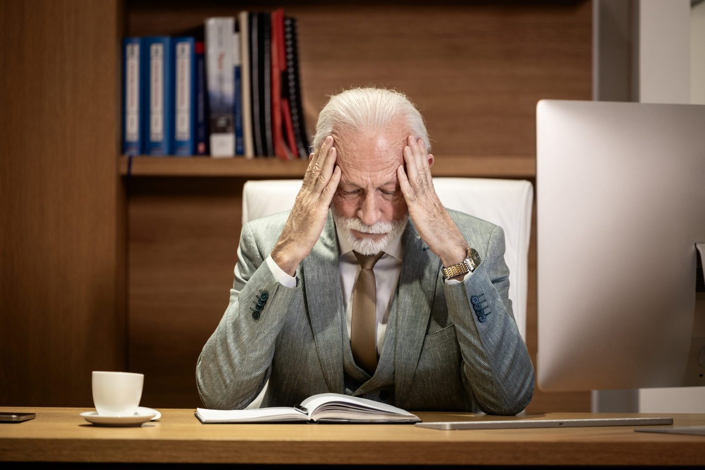 Stressed rich man at desk
