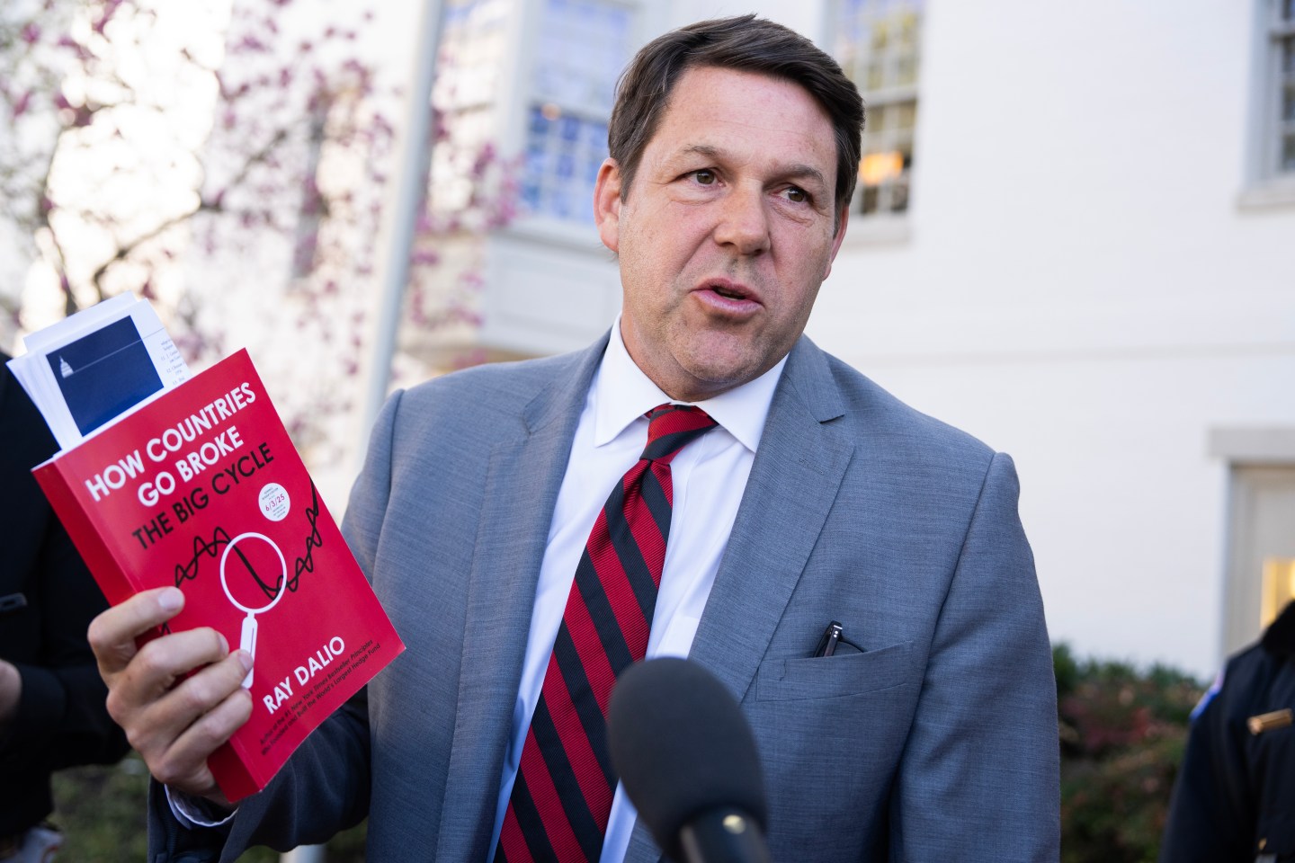 Rep. Jodey Arrington, R-Texas, holds a copy of the Ray Dalio book, "How Countries Go Broke," outside the Capitol Hill Club after a meeting of the House Republican Conference on Tuesday, March 25, 2025.