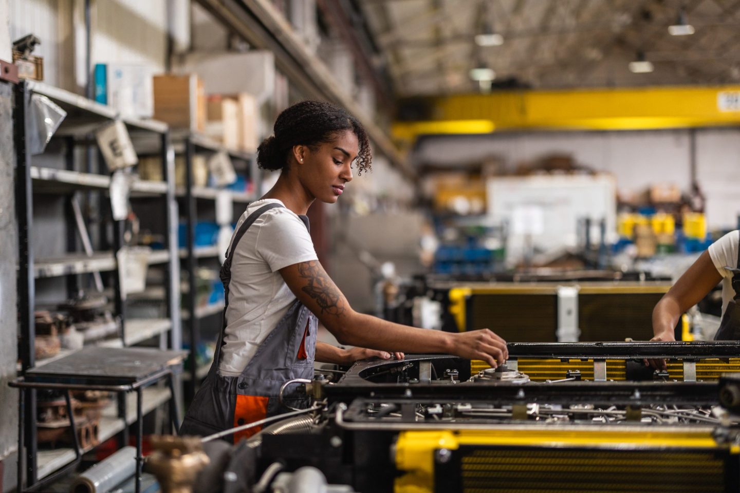 Young worker fixing parts of a car