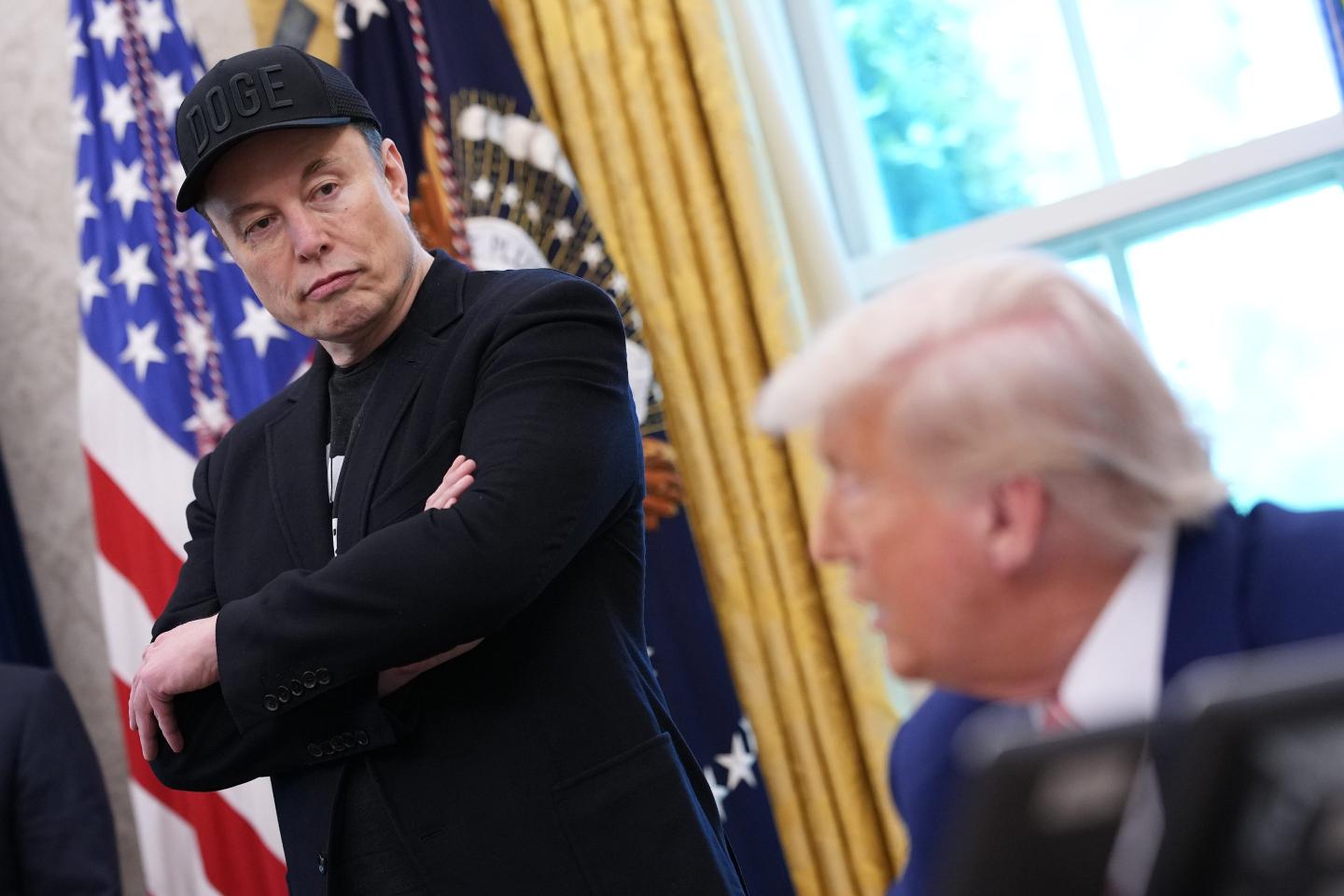 Tesla CEO Elon Musk listens as U.S. President Donald Trump speaks to reporters in the Oval Office of the White House on May 30, 2025 in Washington, DC.