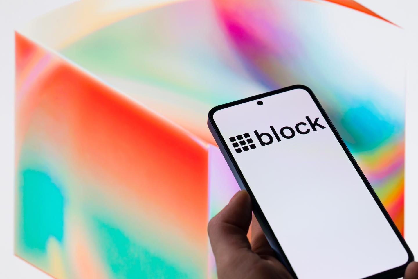 The Block Ink logo is displayed on a mobile phone with the company's bran