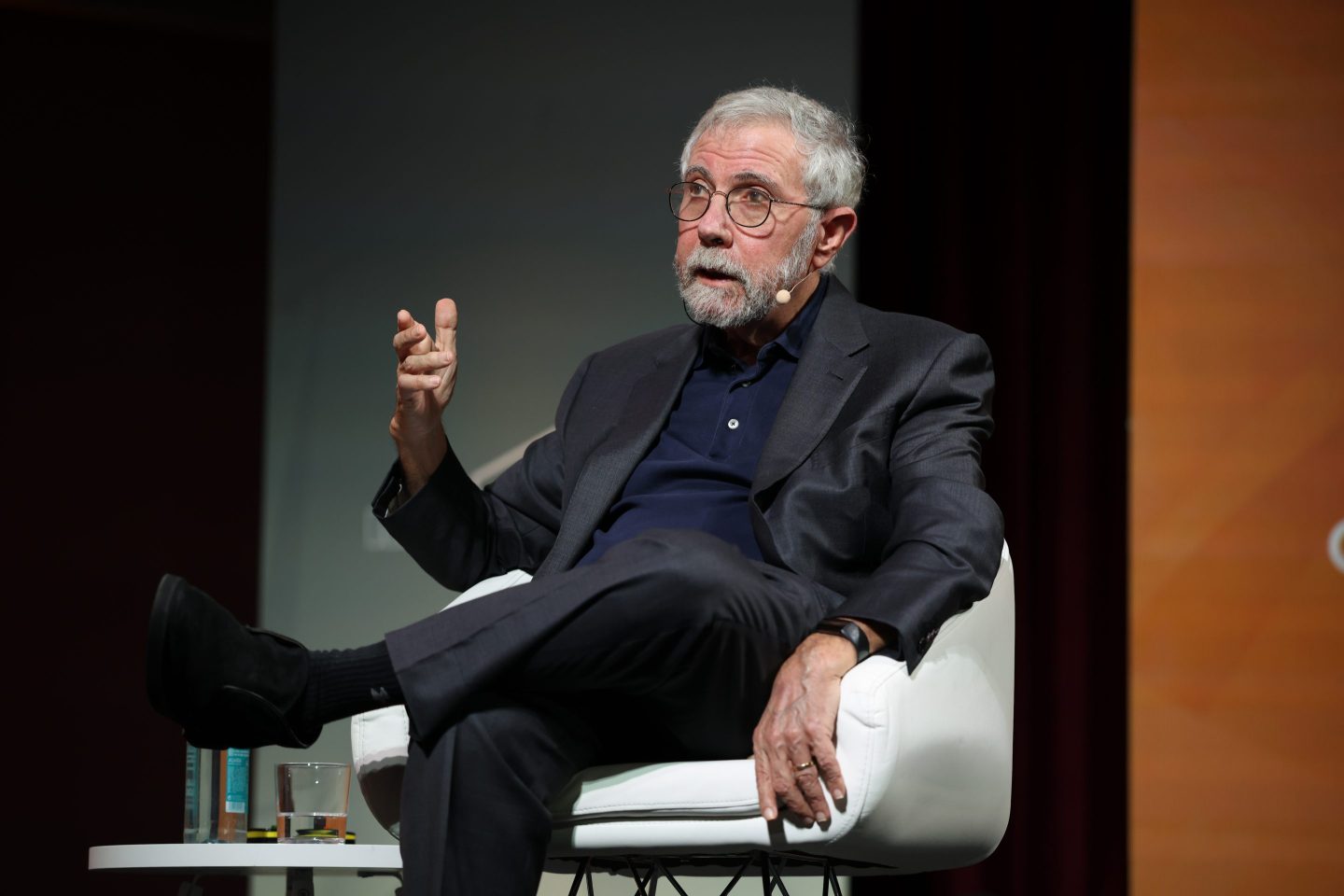 Paul Krugman speaking while seated on stage.
