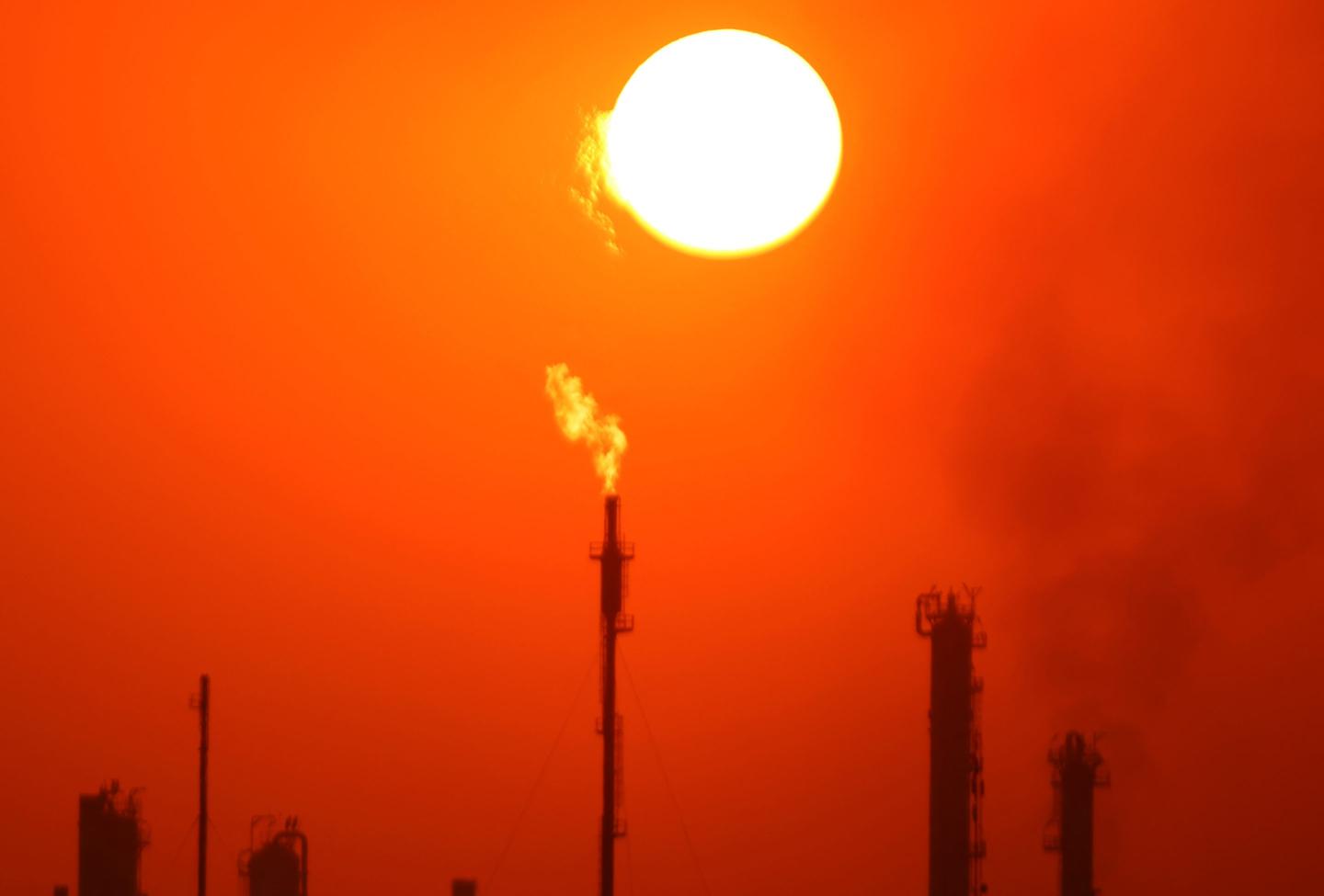 Photo of burning gas flares at a refinery