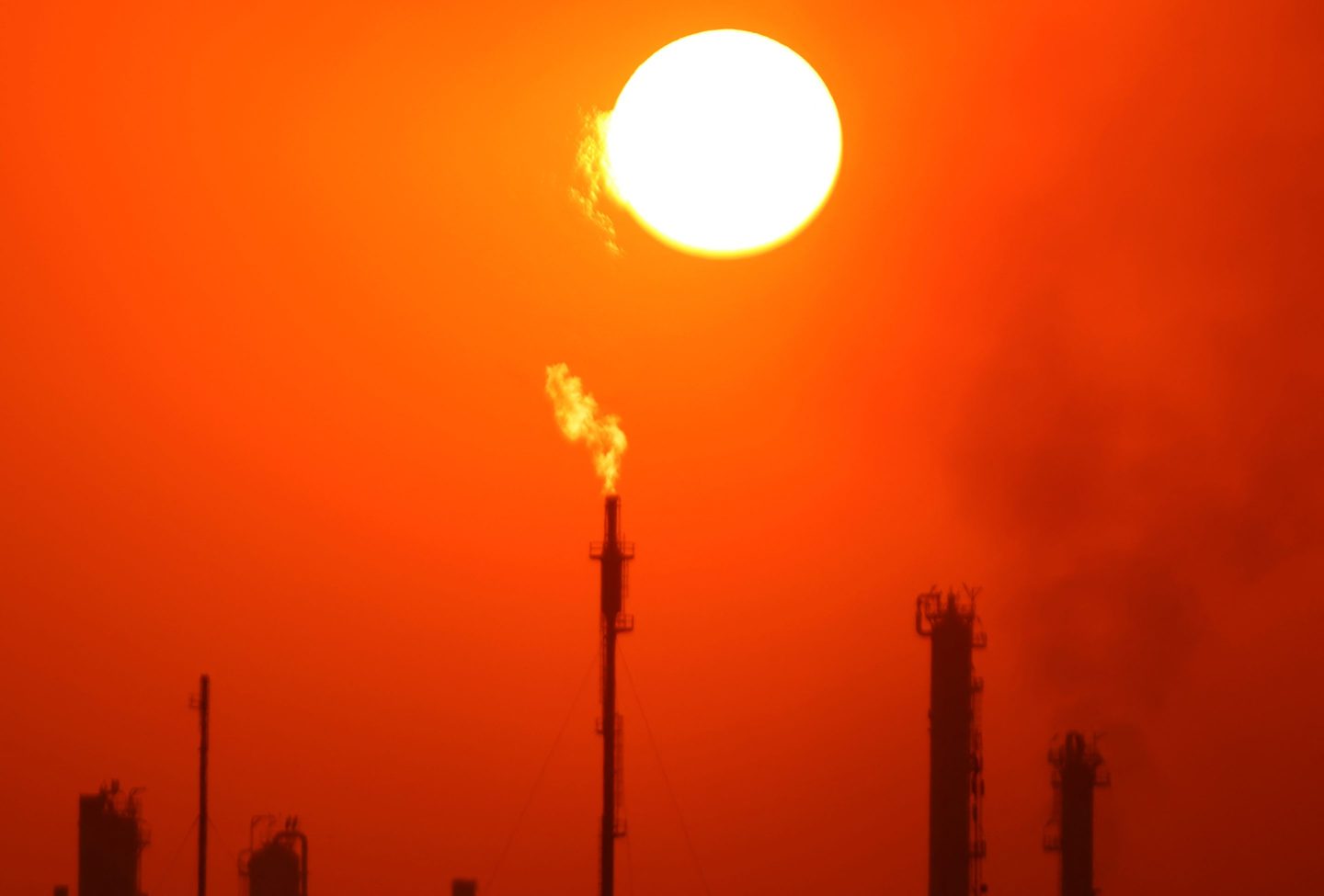 Photo of burning gas flares at a refinery