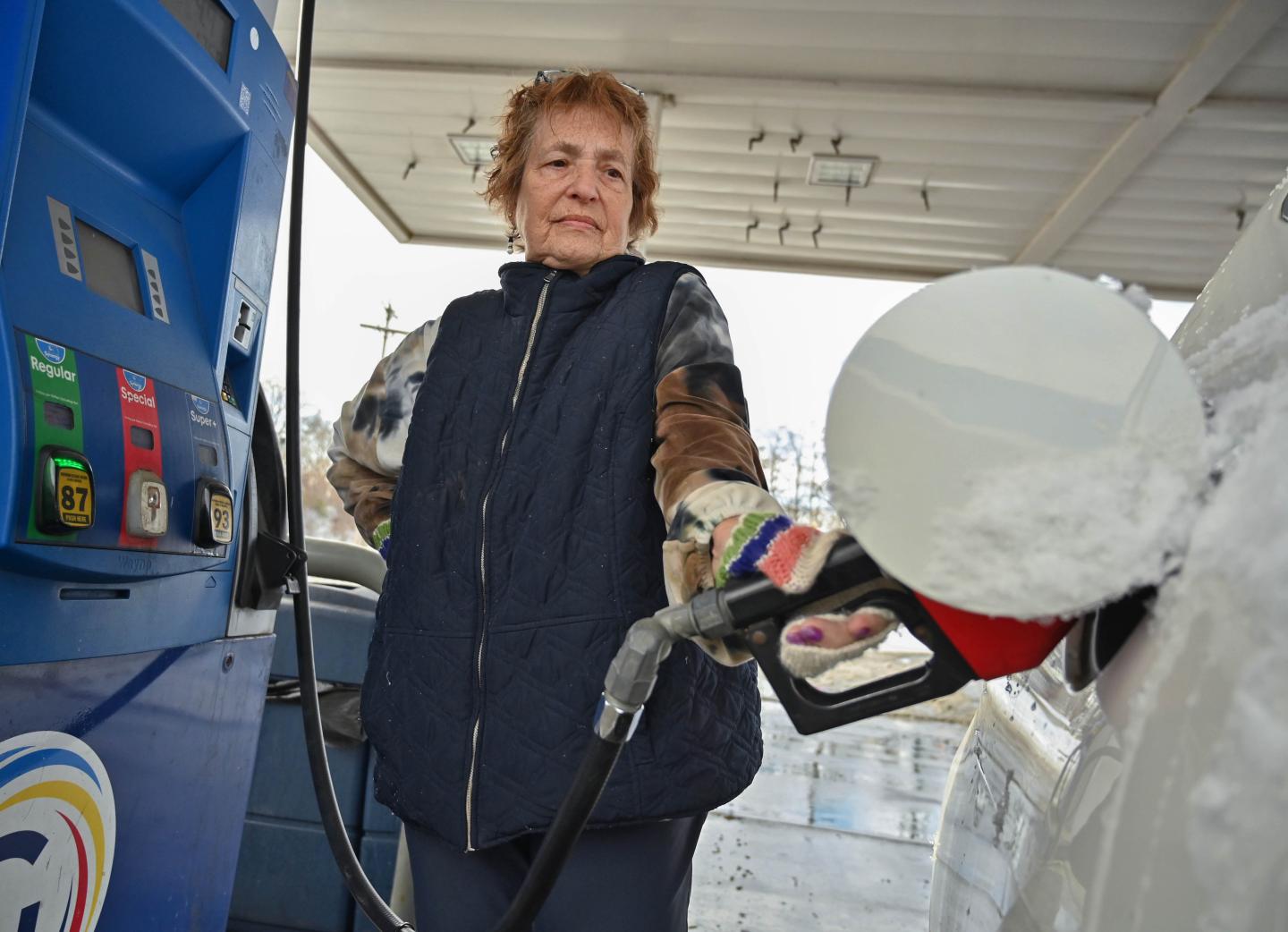Customer Jann Gregg of Schenectady pumps gas at the GasWay Xpress Mart at 1120 Erie Blvd. pump gas on Wednesday, Dec. 3, 2025, in Schenectady, N.Y.
