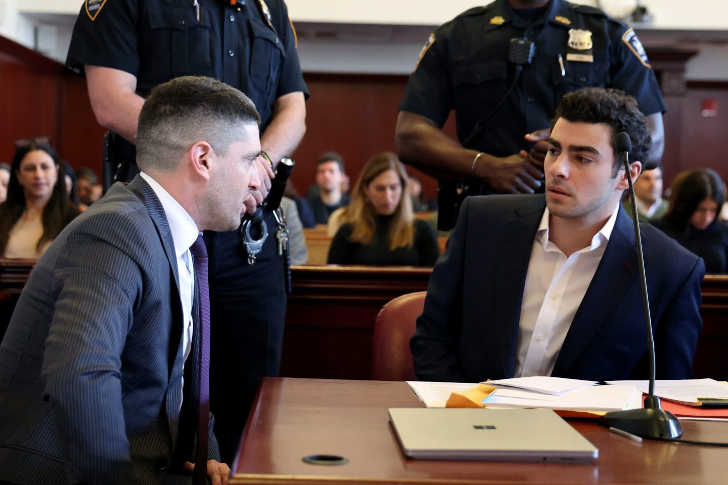 Mangione speaks with his lawyers