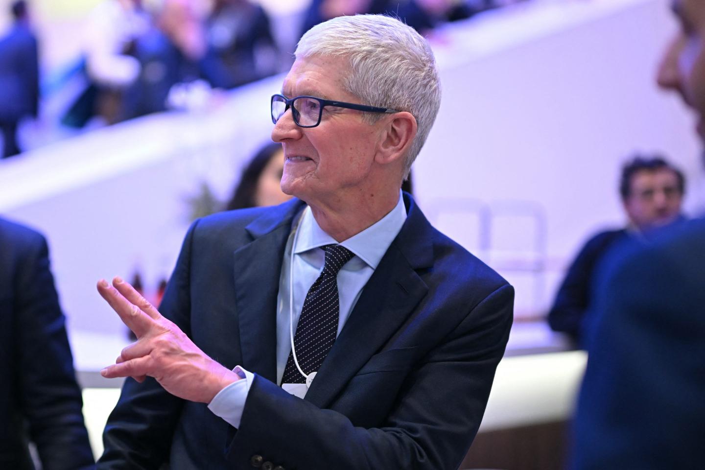 U.S. businessman Tim Cook gestures as he departs after a business leaders reception with the U.S. President on the sidelines of the World Economic Forum (WEF) annual meeting in Davos on January 21, 2026.