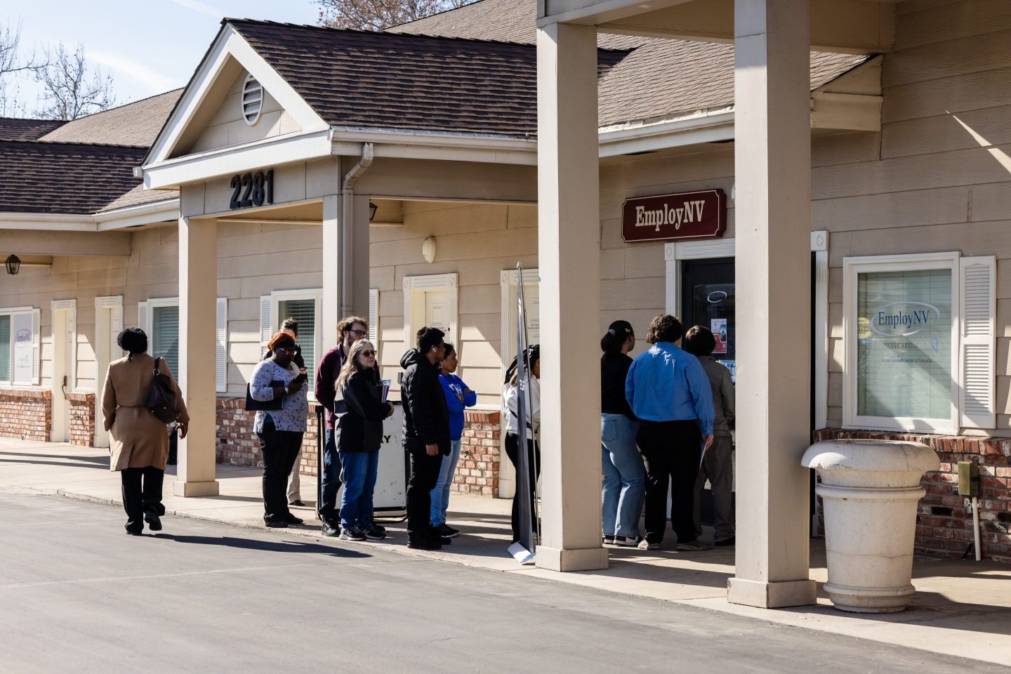 People wait outside a building