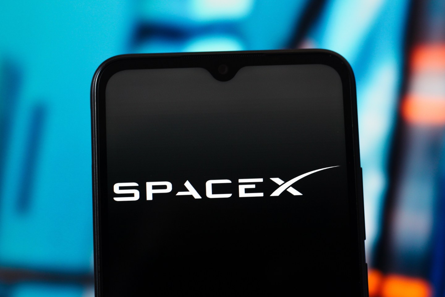 In this photo illustration, the SpaceX logo is seen displayed on a smartphone screen.