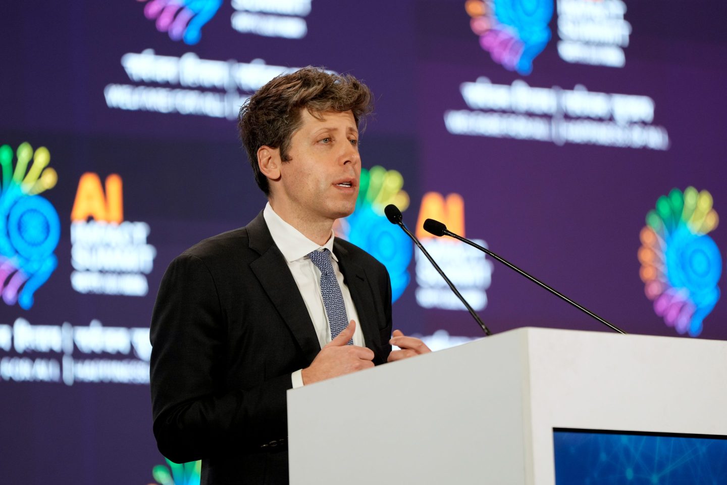 Sam Altman speaking into a mic.