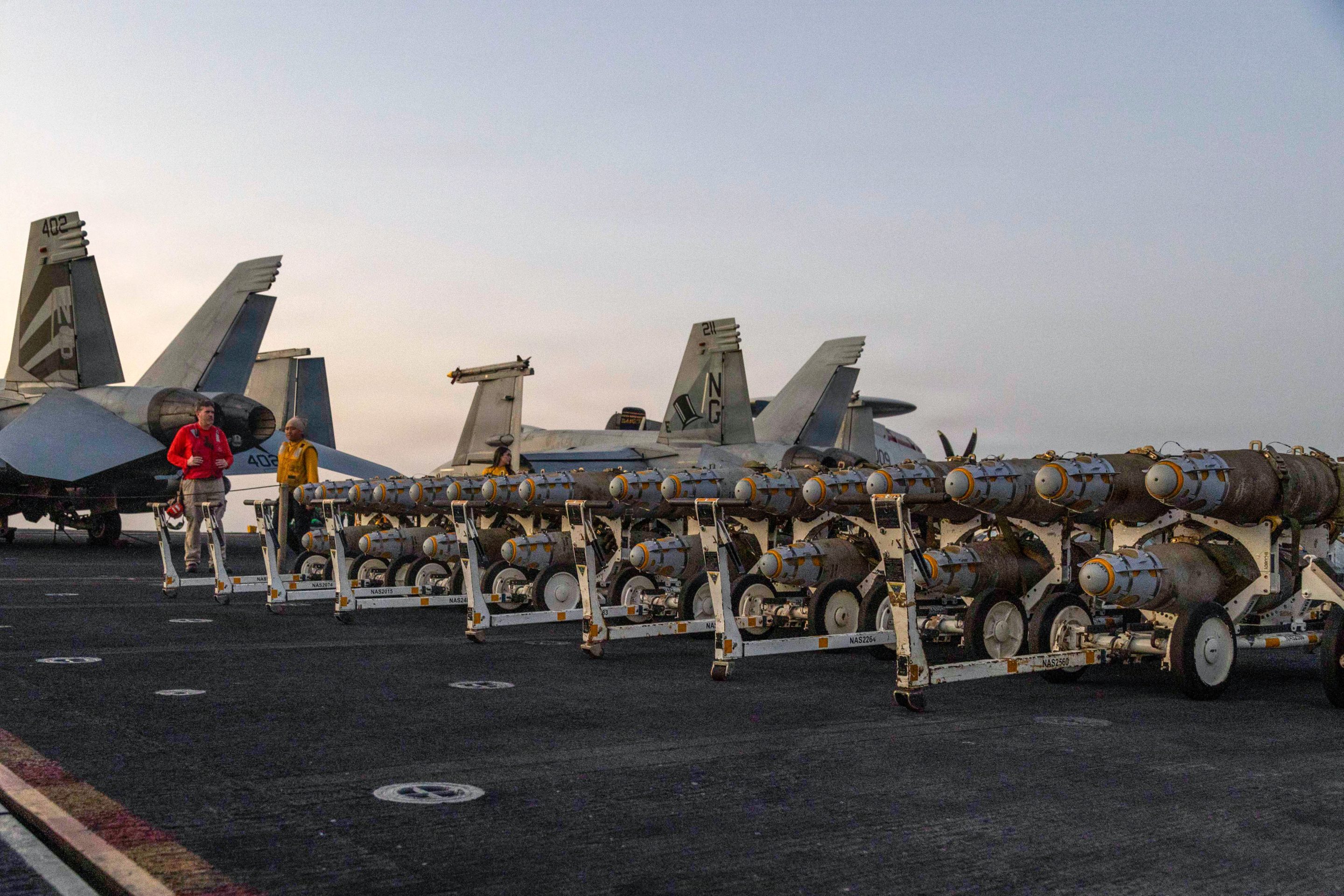 Sailors transfer ordnance on the flight deck of the USS Abraham Lincoln (CVN 72), on February 27, 2026 in the Arabian Sea. 