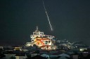 An intercepted projectile falls into the sea near Dubai's Palm Jumeirah archipelago on March 1, 2026. The United States and Israel launched strikes against Iran on February 28, killing Iran's supreme leader and top military leaders, prompting authorities to retaliate with strikes on Israel and US bases across the Gulf. (Photo by FADEL SENNA / AFP)