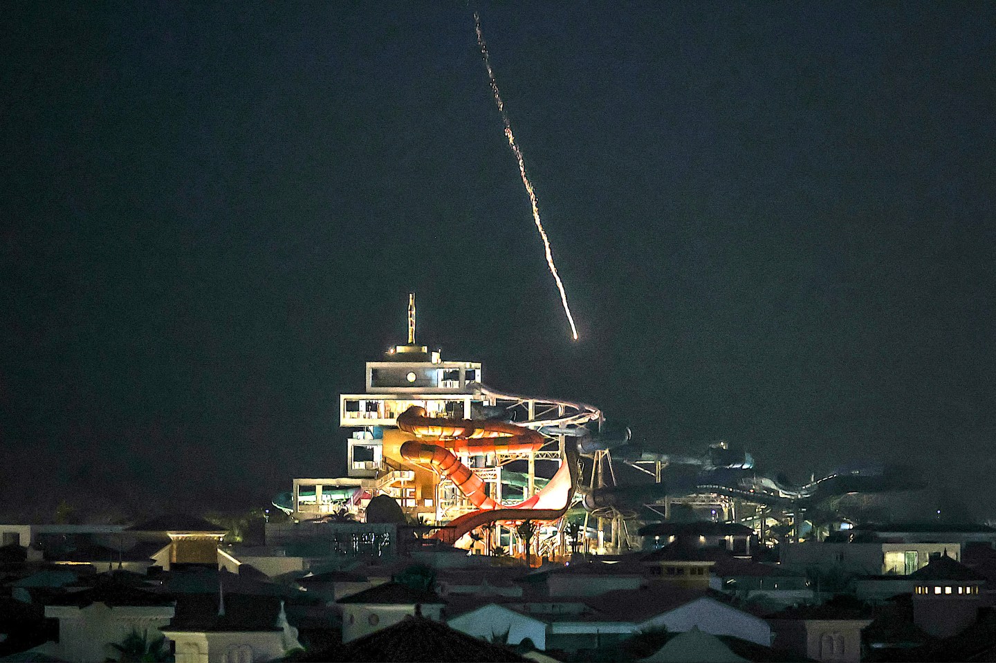 An intercepted projectile falls into the sea near Dubai's Palm Jumeirah archipelago on March 1, 2026. The United States and Israel launched strikes against Iran on February 28, killing Iran's supreme leader and top military leaders, prompting authorities to retaliate with strikes on Israel and US bases across the Gulf. (Photo by FADEL SENNA / AFP)