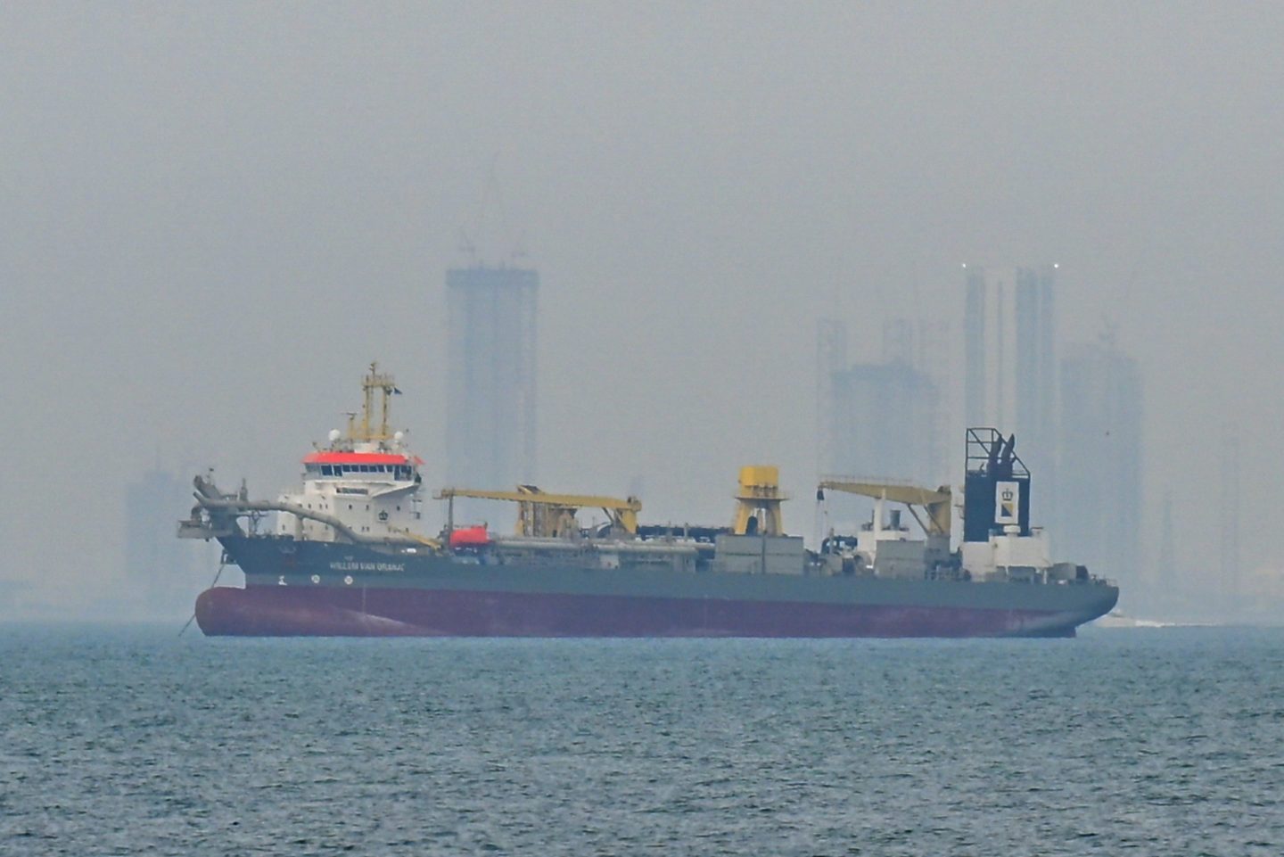 A commercial ship anchored off the coast of Dubai.