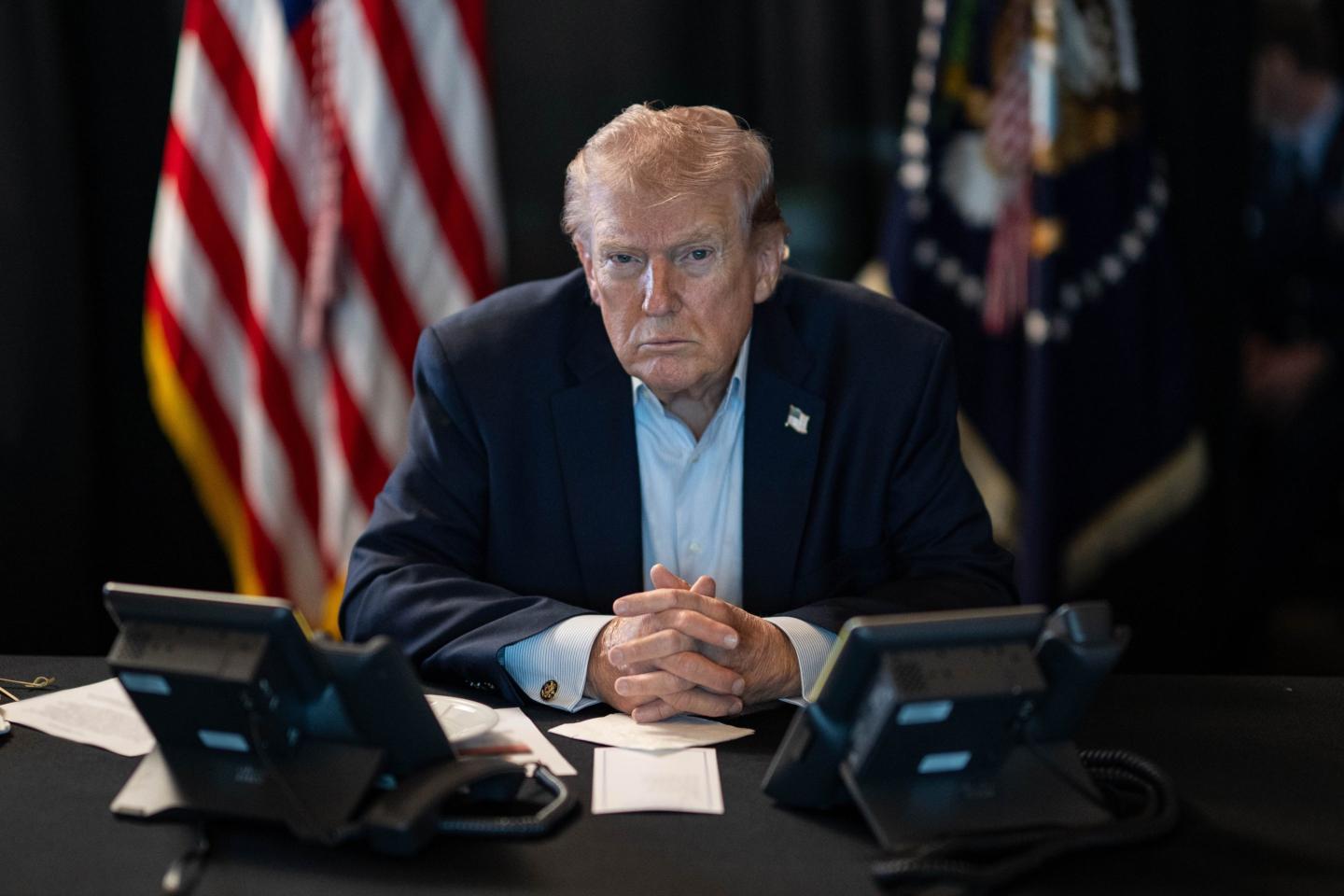 U.S. President Donald J. Trump sits at a table monitoring military operations during Operation Epic Fury against Iran, with U.S. flags visible behind him, in Washington, United States, on March 02, 2026.