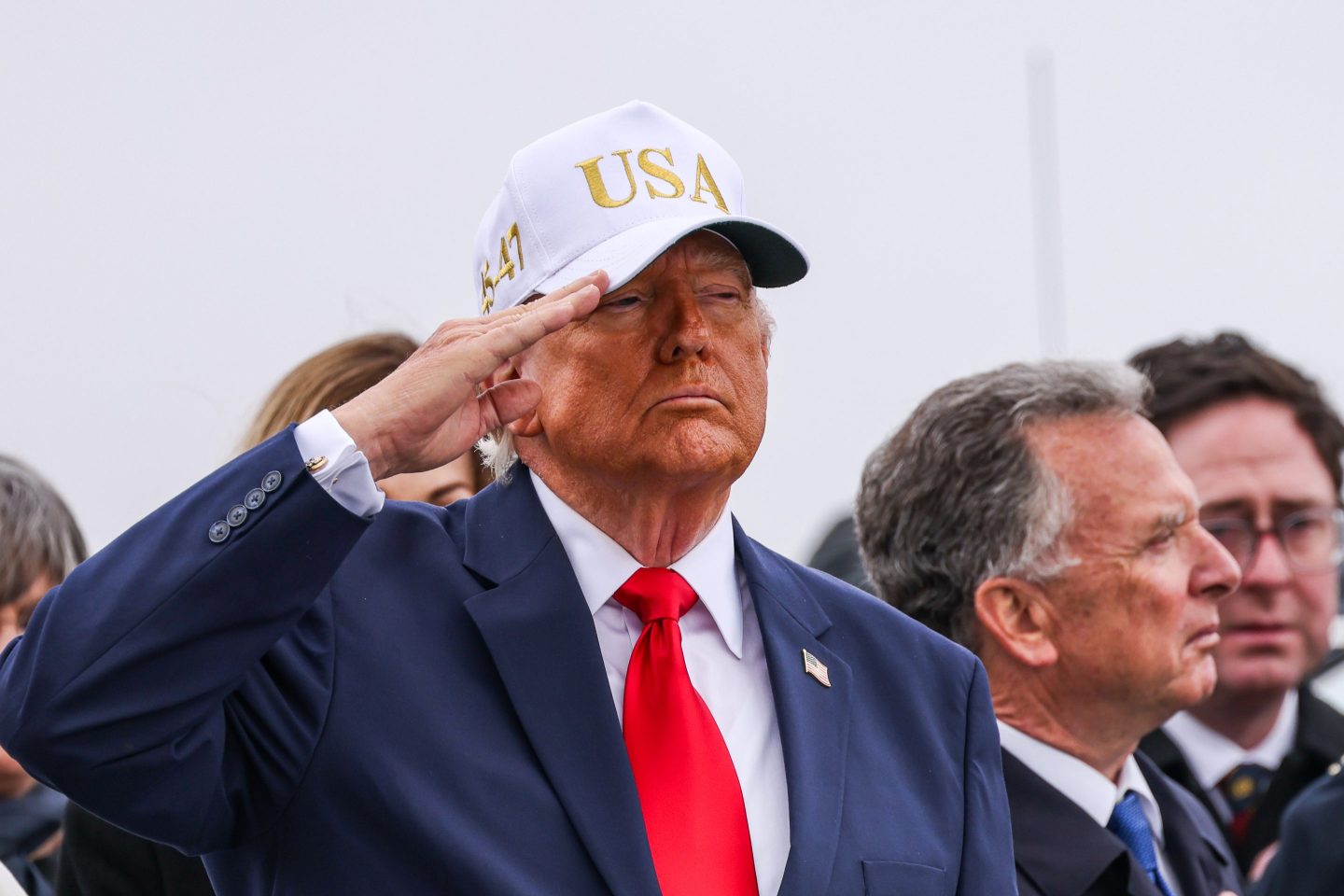 US President Donald Trump salutes during a dignified transfer at Dover Air Force Base in Dover, Delaware, US, on Saturday, March 7, 2026.