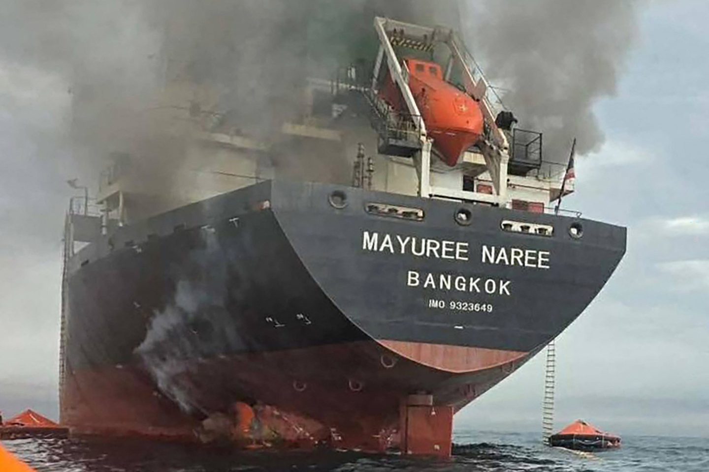 Handout photo taken on March 11, 2026 and released by the Royal Thai Navy shows smoke rising from the Thai bulk carrier 'Mayuree Naree' near the Strait of Hormuz after an attack. A Thai bulk carrier travelling in the crucial Strait of Hormuz was attacked March 11, with 20 crew members rescued so far, the Thai navy said.