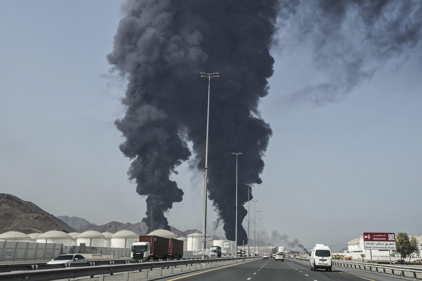 Smoke rises from the direction of an energy installation in the Gulf emirate of Fujairah on March 14, 2026. Smoke could be seen rising from the direction of a major UAE energy installation on March 14, in what appeared to be the latest strike targeting the Gulf's petroleum facilities hours after the US struck Iran's Kharg Island.