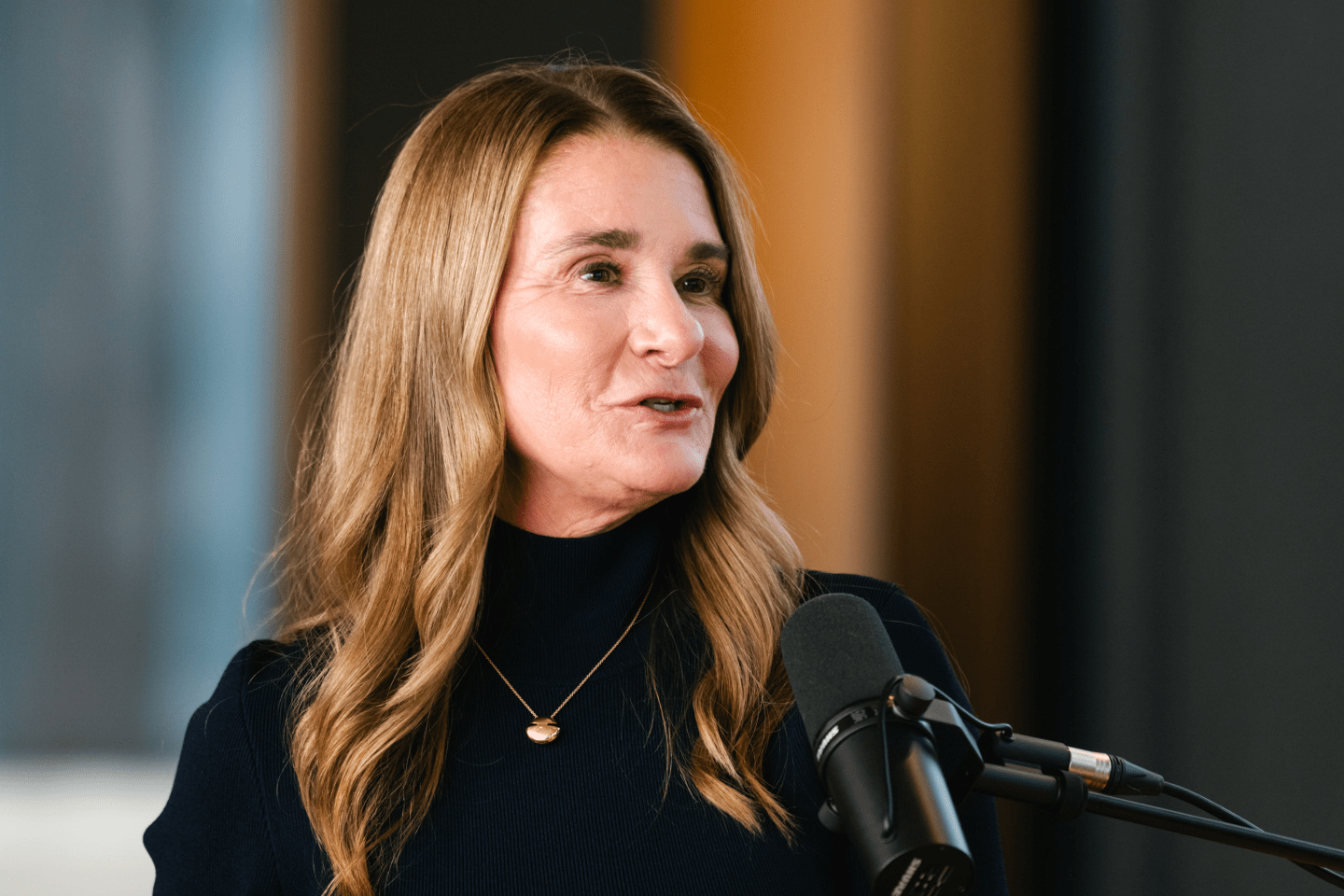 Melinda French Gates with a podcast microphone in front of her
