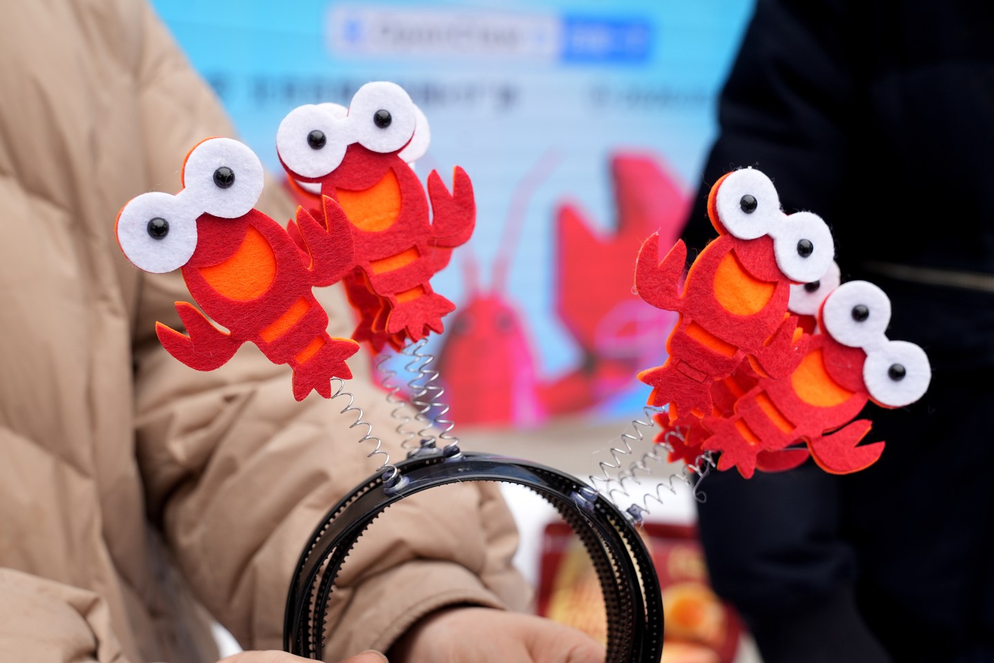 Lobster-themed headbands at Baidu Inc.'s OpenClaw Lobster Market event in Beijing, China, on Tuesday, March 17, 2026. Baidu Inc. is betting on the breakout success of OpenClaw to offset a decline in its core business. Its latest push: smart speakers serving as a voice-controlled remote for the viral AI agent. Photographer: Andrea Verdelli/Bloomberg via Getty Images