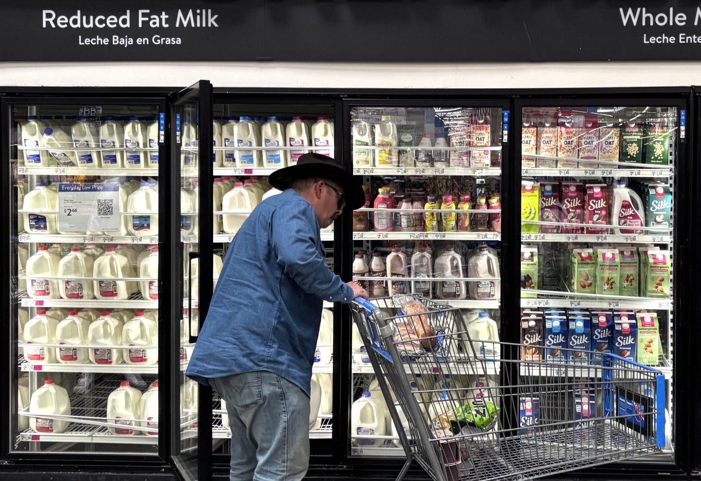 A man walks by the dairy section at a supermarket in Houston, Texas, on March 17, 2026.