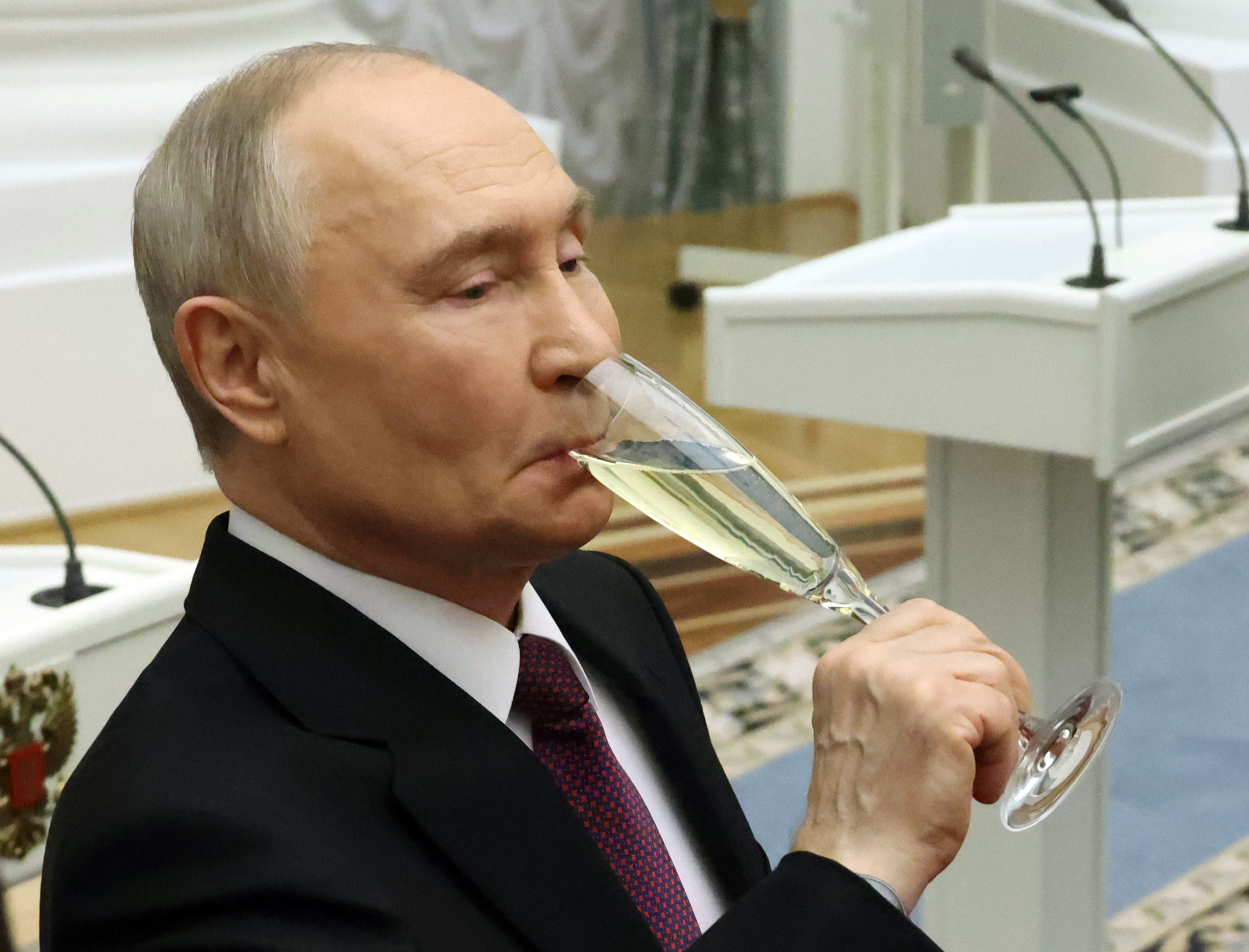 Russian President Vladimir Putin drinks Champagne during an awards ceremony at the Kremlin, March 19, 2026, in Moscow.