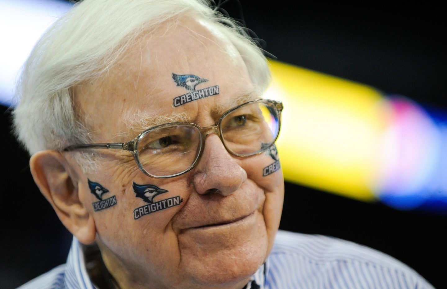 Warren Buffett with Creighton basketball temporary tattoos on his face