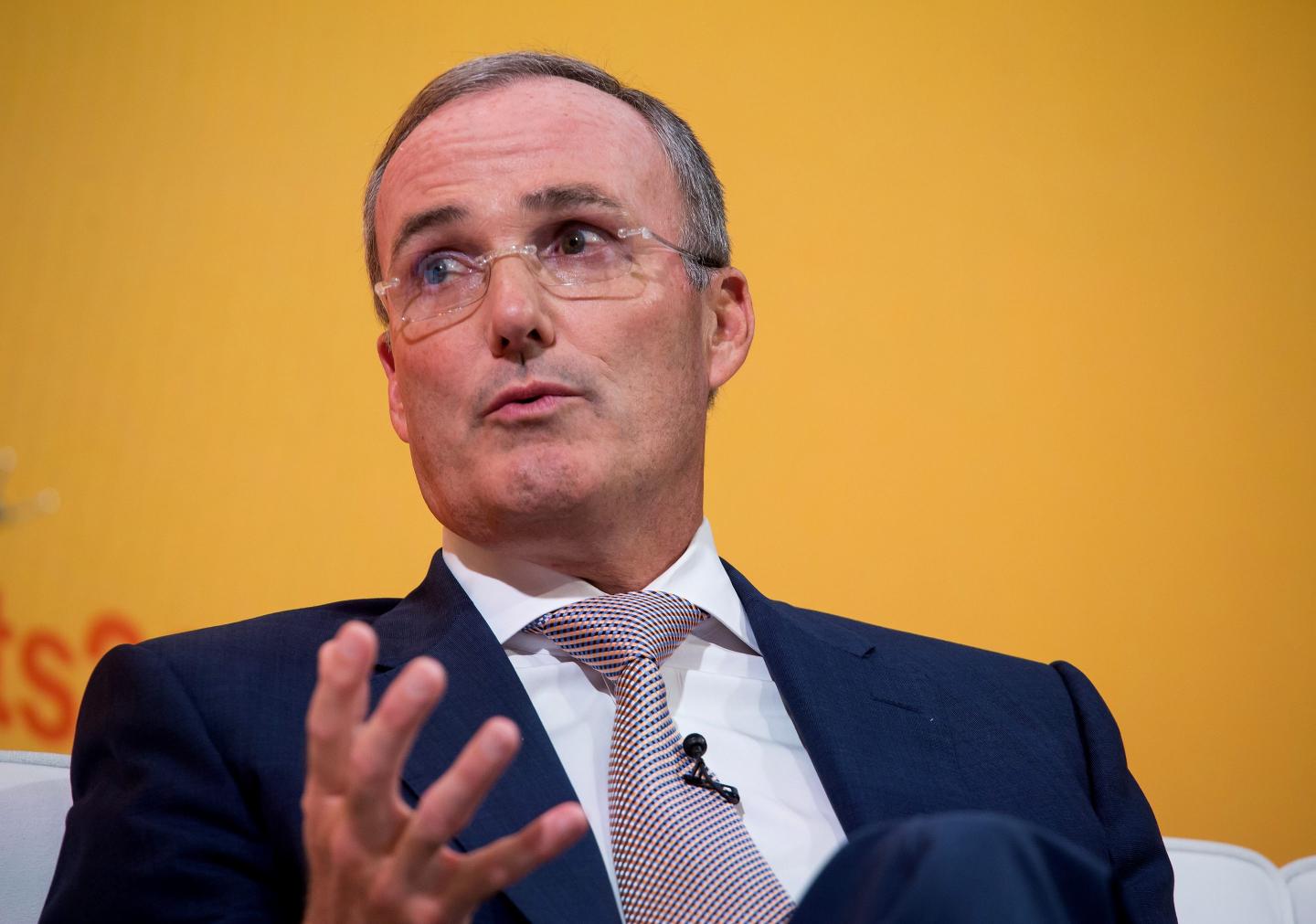 Man in a suit in front of a yellow background