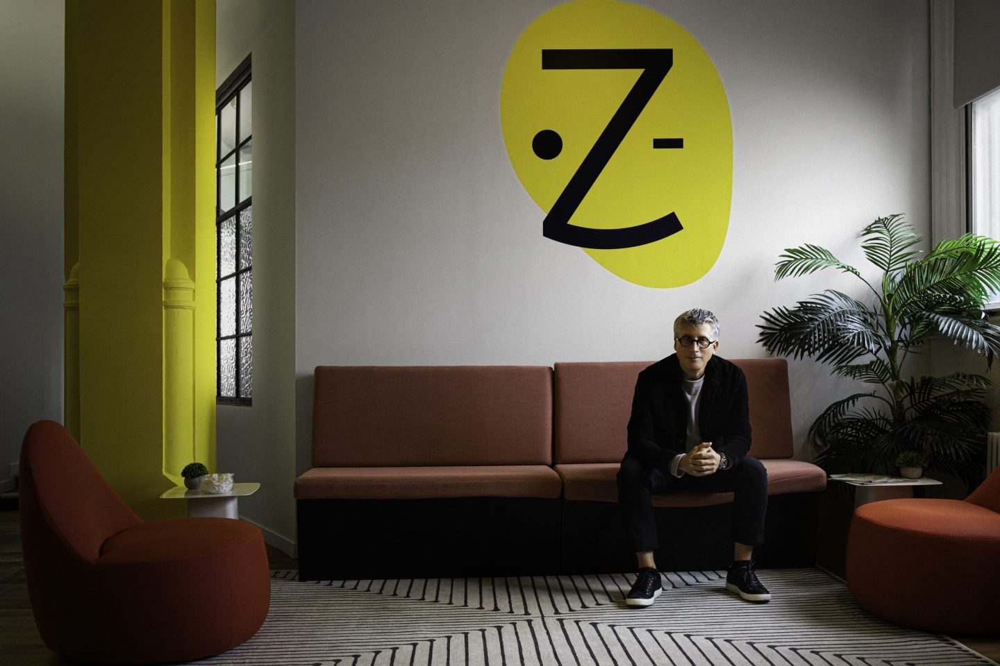 Oliver Kharraz, CEO of Zocdoc, sits on a couch.