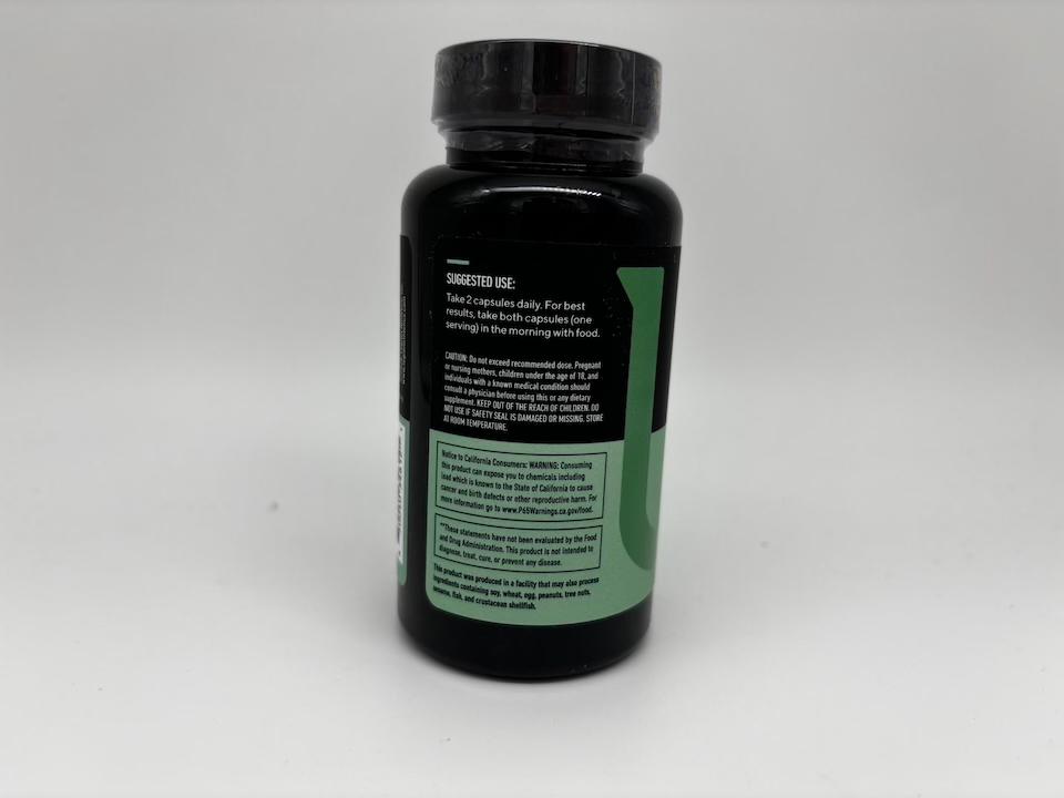 A bottle displaying nutritional facts and ingredients on a green-labeled bottle of Legion Biome Probiotic.