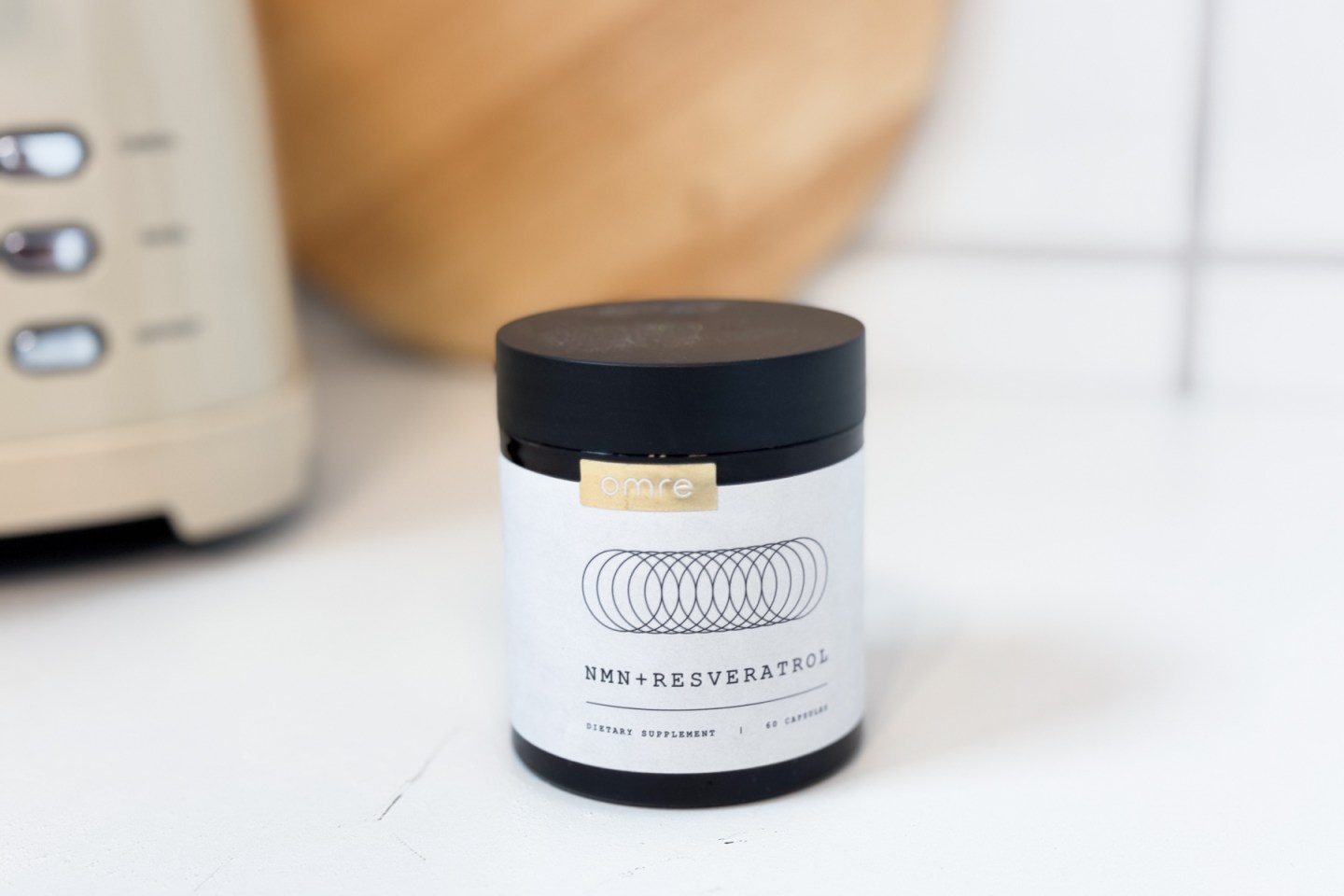 A jar of Omre NMN sitting on a white countertop.