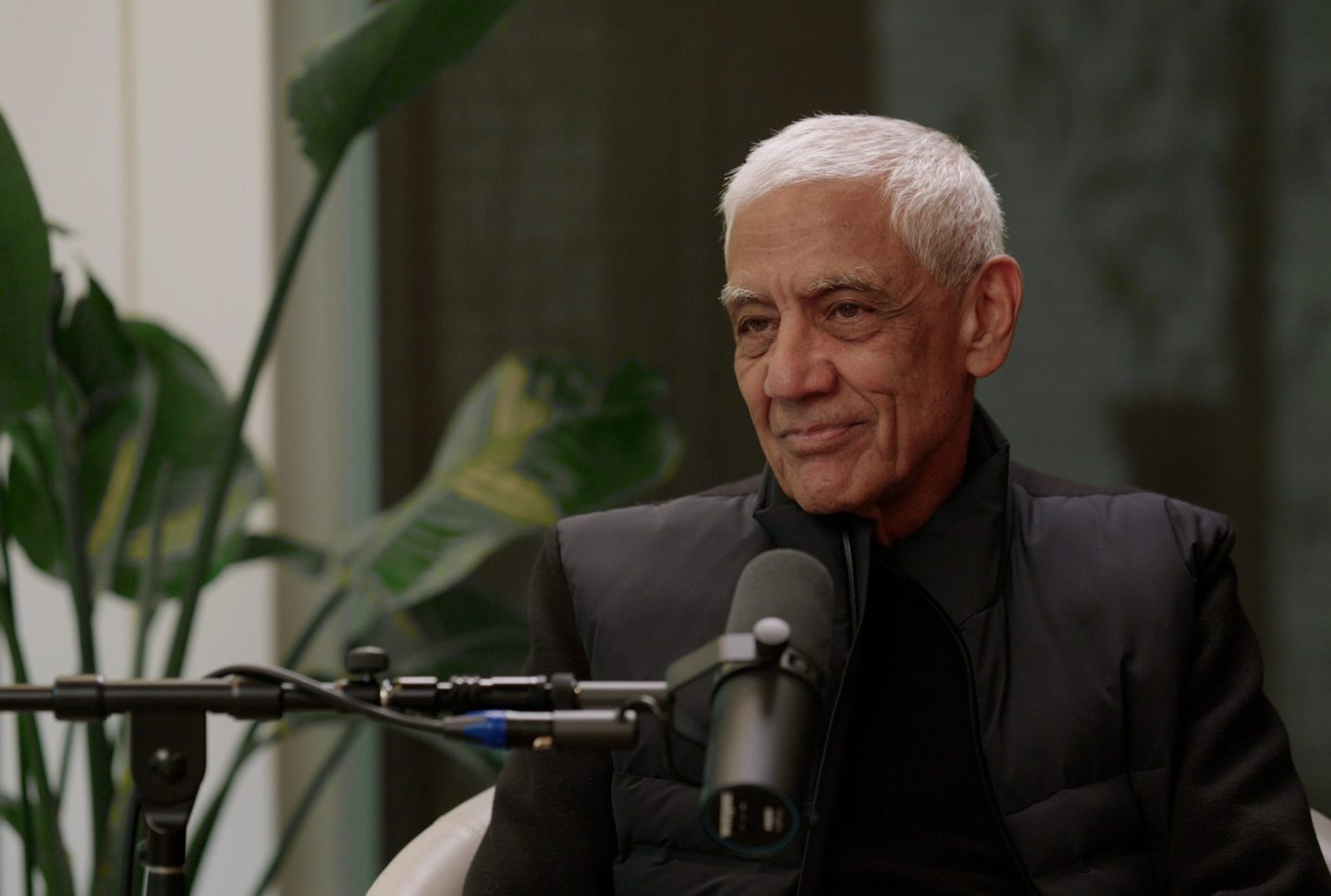 Vinod Khosla sits in front of a microphone.