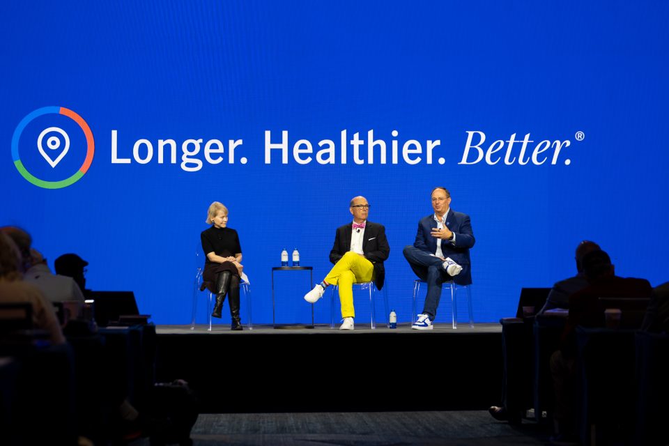 Three people sitting on a stage.