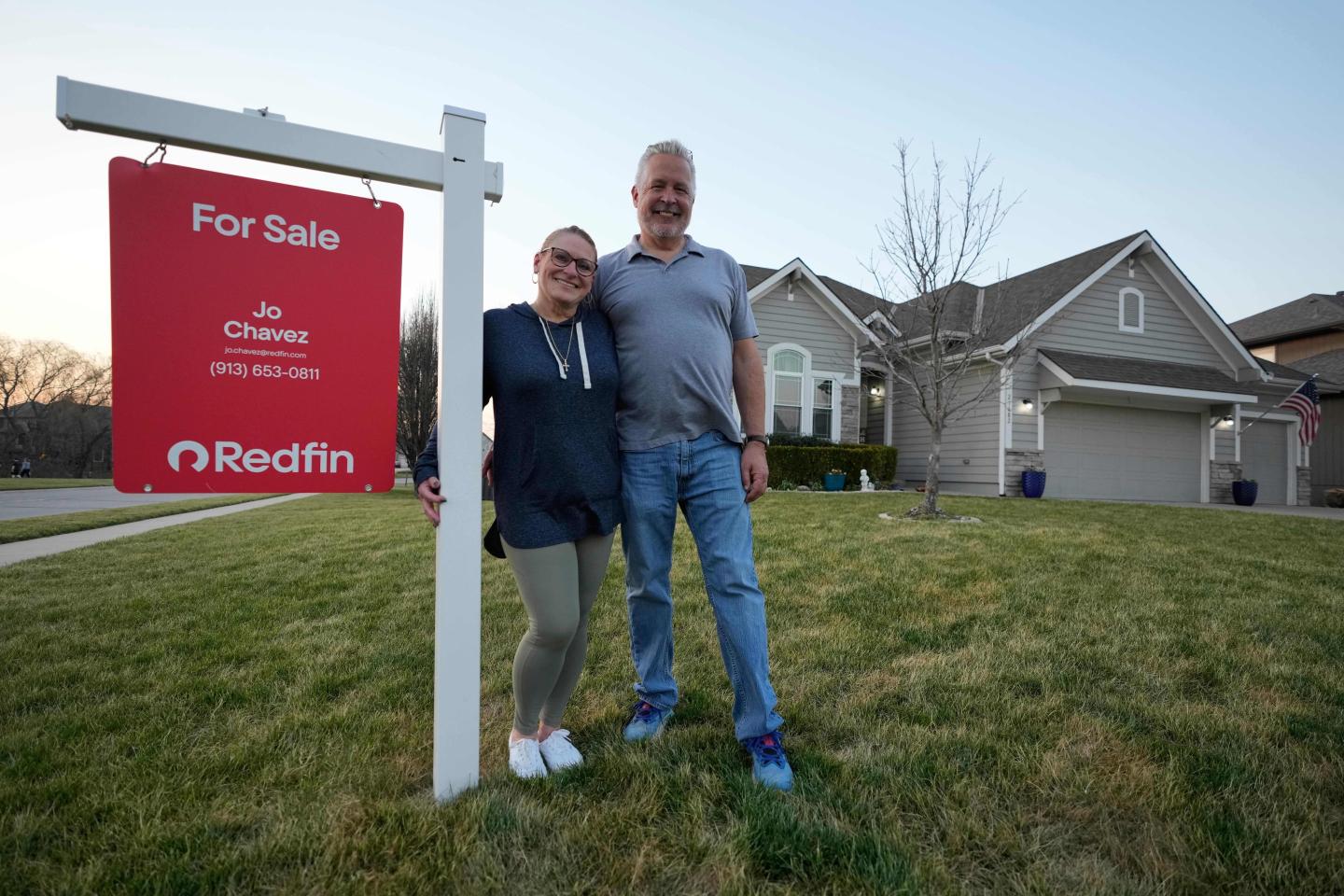 Gail and David Sanders stand in front of their home which they have been trying to sell Wednesday, March 25, 2026, in Olathe, Kan.