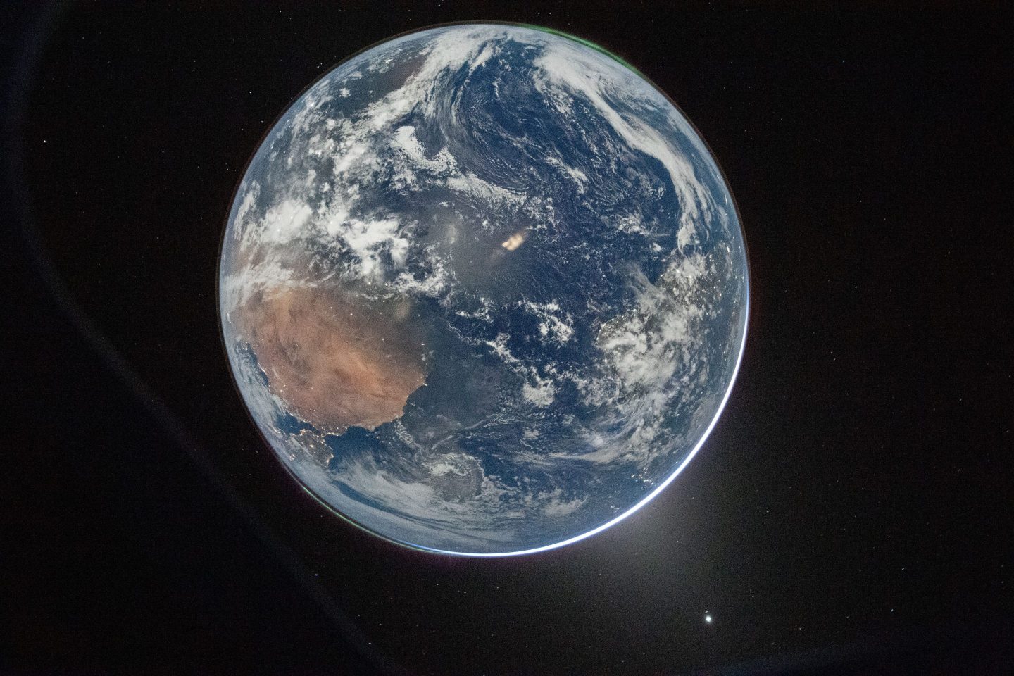 This image provided by NASA shows a view of Earth taken by NASA astronaut and Artemis II Commander Reid Wiseman from of the Orion spacecraft's window after completing the translunar injection burn on April 2, 2026. (NASA via AP)