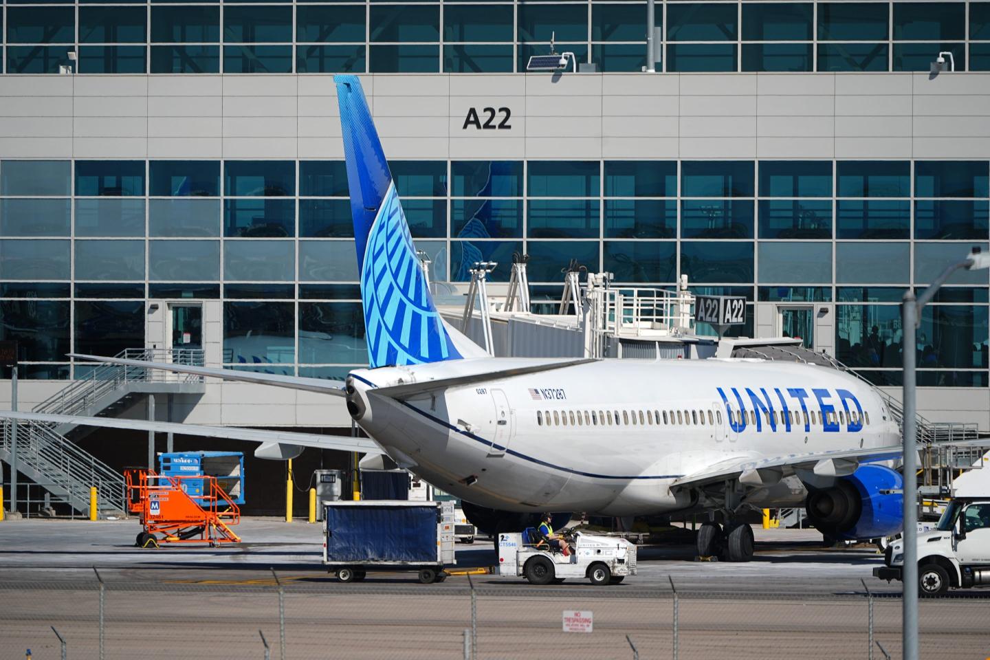 A United Airlines jetliner sits at a gate along the A concourse of Denver International Airport, March 20, 2026, in Denver. 