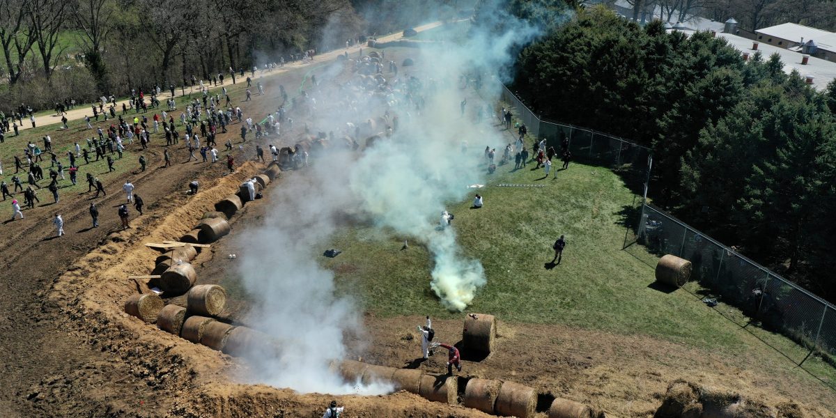About 1,000 animal welfare activists tried to storm a beagle research facility protected by a manure-filled trench, hay bales and a barbed-wire fence