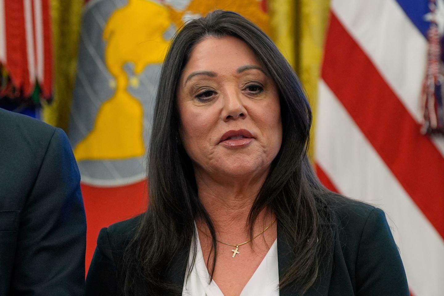 Labor Secretary Lori Chavez-DeRemer listens as President Donald Trump speaks with reporters while signing executive orders in the Oval Office of the White House, April 23, 2025.