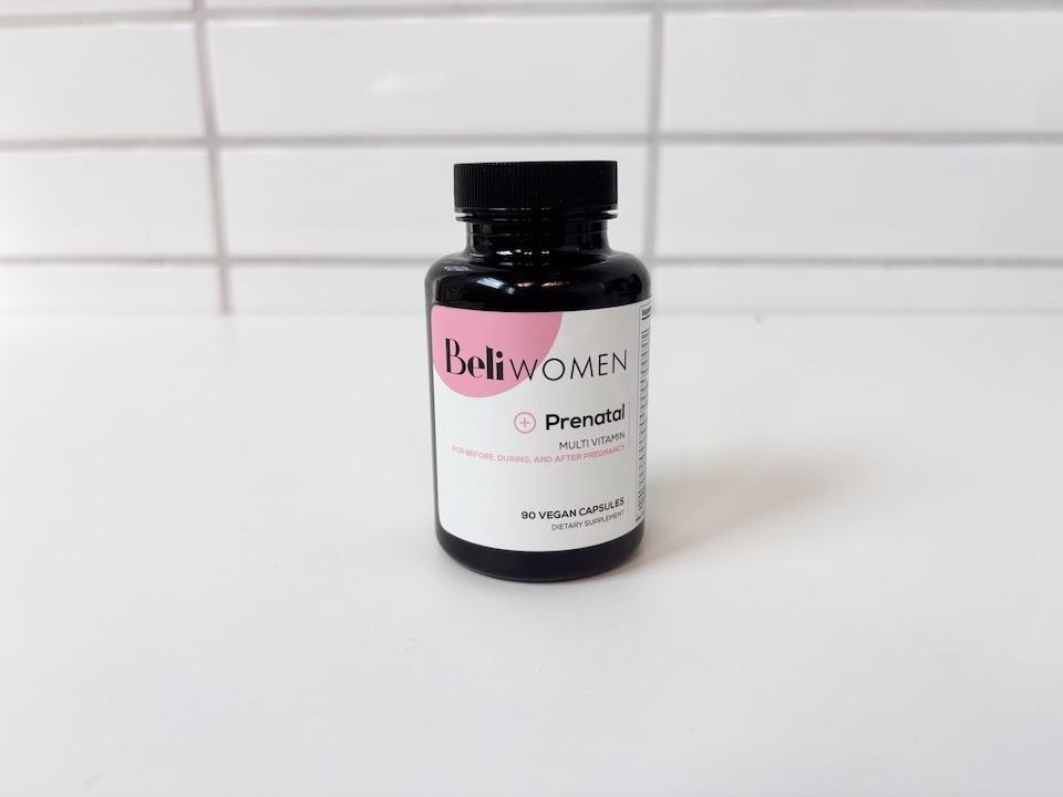 A bottle of Beli Women Prenatal Vitamins sitting on a white countertop.