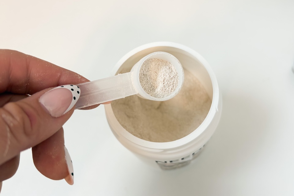 A hand using a scooper to get a scoop of Needed Sleep Relaxation and Support.