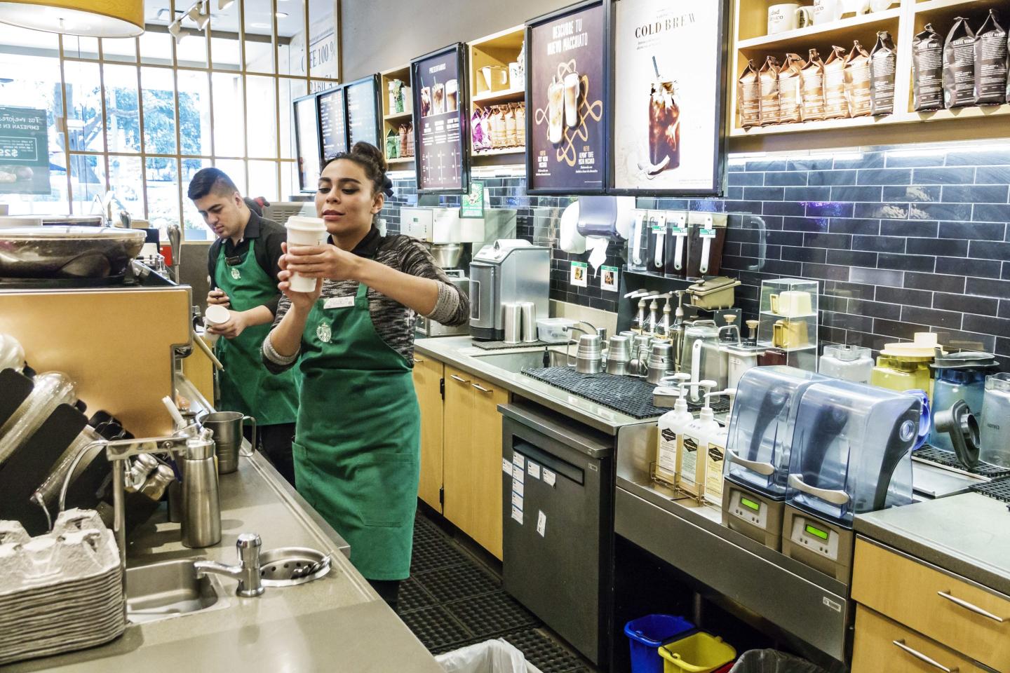Starbucks baristas working in store