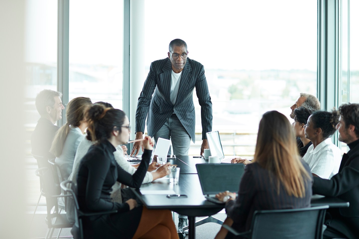 Business people in large modern meeting room