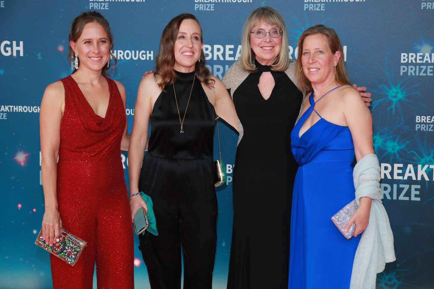 Esther, Janet, Susan, and Anne Wojcicki stand in formal dresses and pose.
