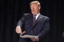 U.S. President Donald Trump holds a newspaper