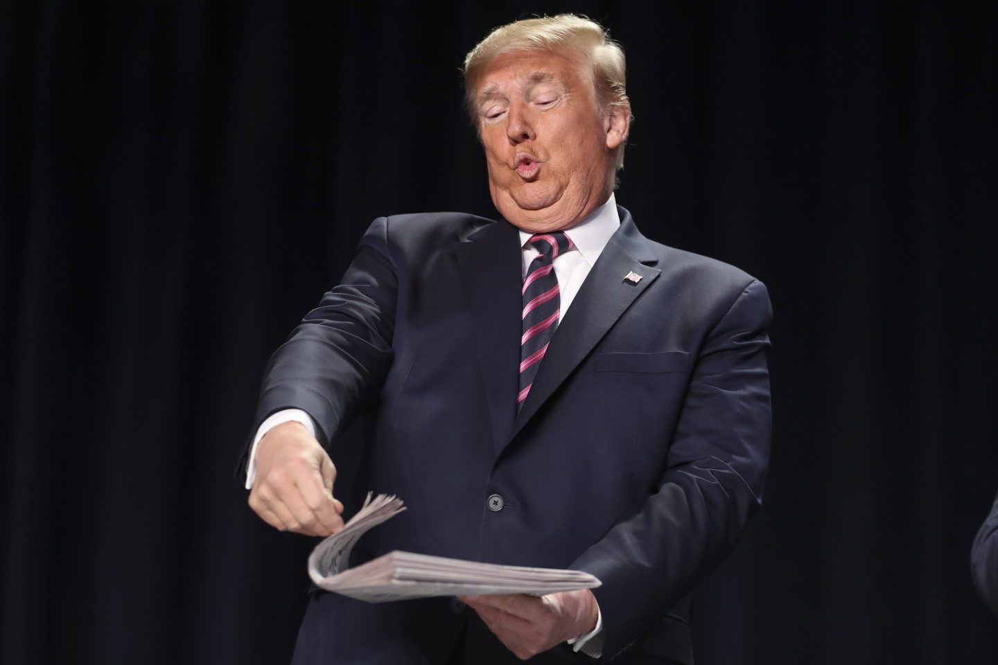 U.S. President Donald Trump holds a newspaper