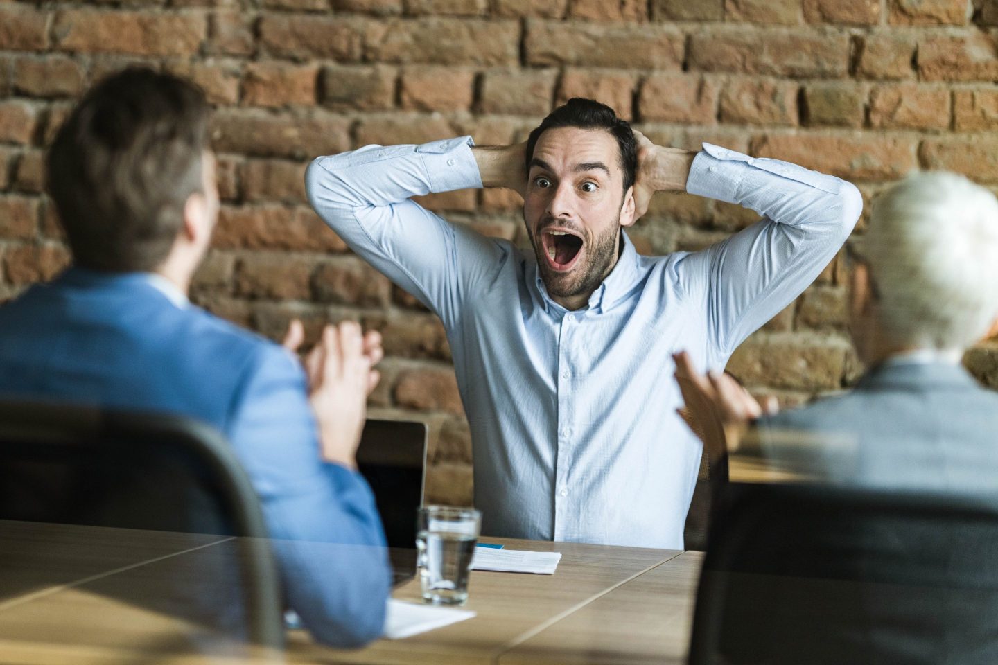 Young man looking surprised during a job interview